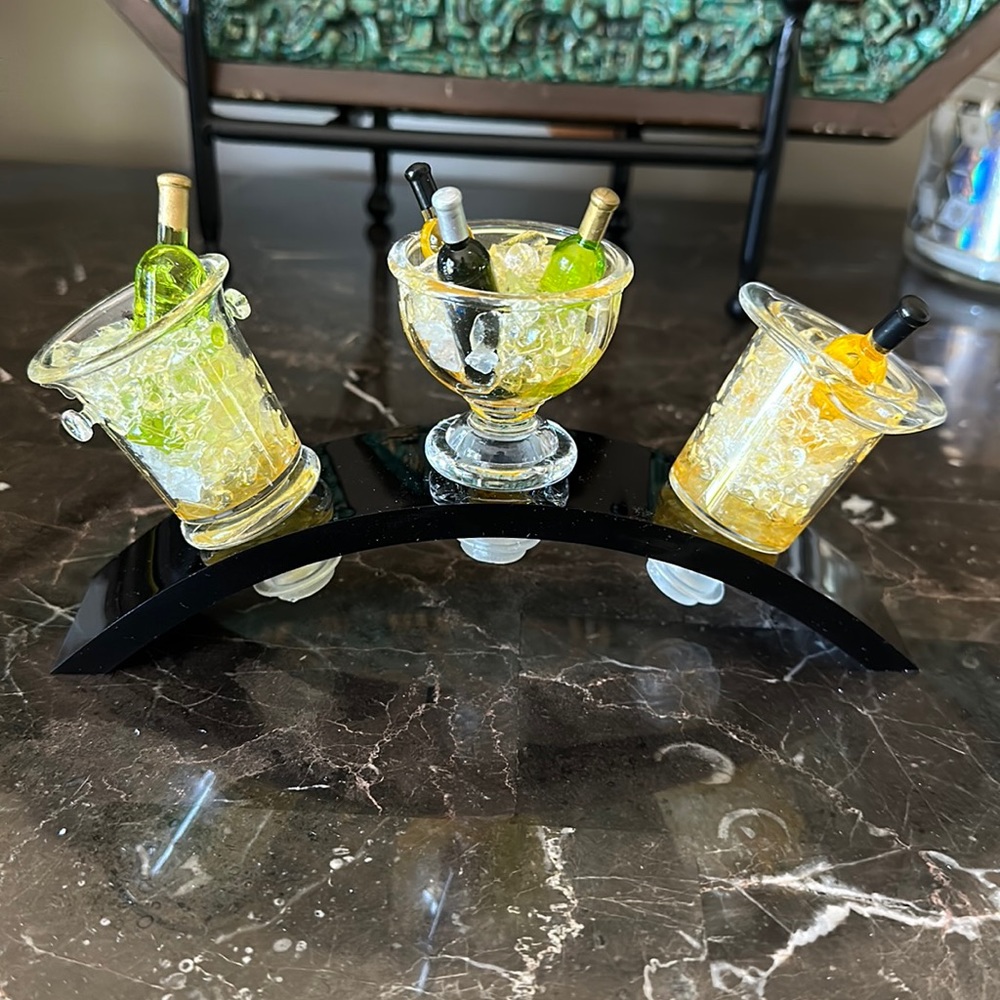 Set of 3 acrylic wine stoppers with stand.